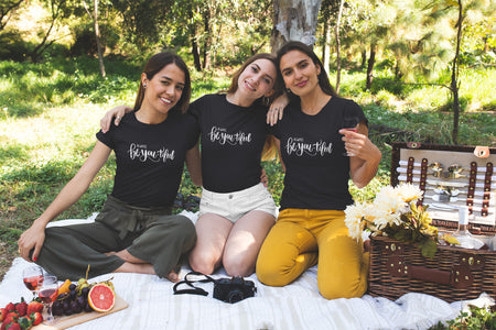 Group of women wearing black t-shirts having a picnic